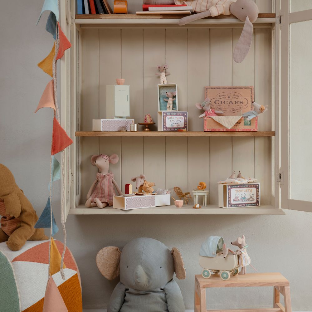 Maileg mice and animal soft toys displayed with miniature furniture and accessories in a cosy, light-filled nursery setting
